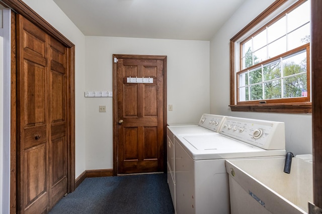 laundry room with a sink, laundry area, washer and dryer, carpet floors, and baseboards