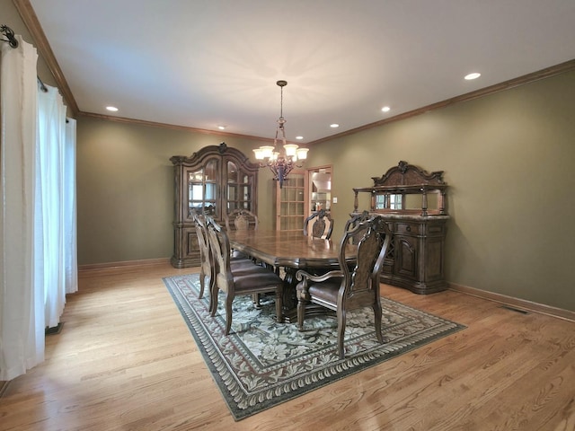 10160 Lancaster Dr, Mokena, IL 60448 - dining room featuring an inviting chandelier, ornamental molding, baseboards, and light wood-type flooring