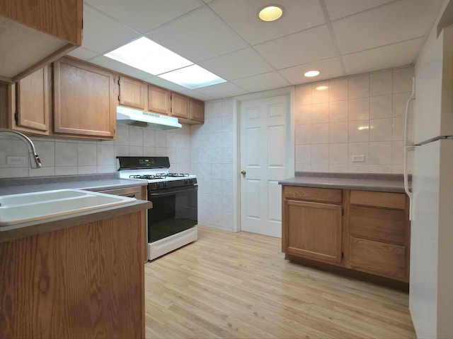 10160 Lancaster Dr, Mokena, IL 60448 - kitchen with a sink, tile walls, white appliances, under cabinet range hood, and light wood-style floors
