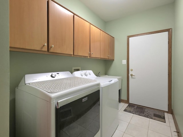 10160 Lancaster Dr, Mokena, IL 60448 - clothes washing area featuring washing machine and clothes dryer, cabinet space, baseboards, and light tile patterned floors