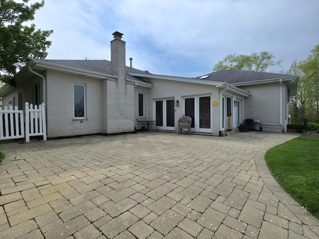 10160 Lancaster Dr, Mokena, IL 60448 - rear view of house with fence, a patio area, a chimney, and brick siding