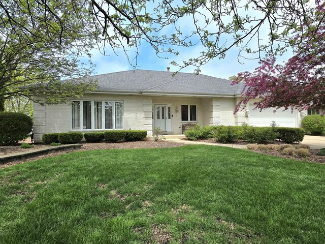 10160 Lancaster Dr, Mokena, IL 60448 - rear view of house with a yard, roof with shingles, brick siding, and an attached garage