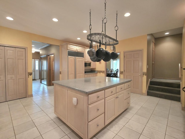 10160 Lancaster Dr, Mokena, IL 60448 - kitchen with built in appliances, recessed lighting, light tile patterned flooring, and a kitchen island