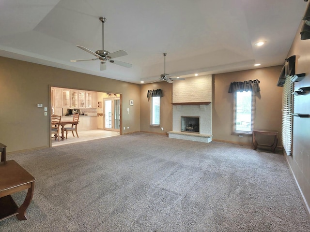 10160 Lancaster Dr, Mokena, IL 60448 - unfurnished living room with a raised ceiling, carpet floors, a ceiling fan, and a healthy amount of sunlight