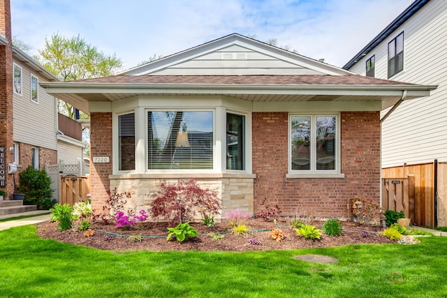 7220 W Ibsen St, Chicago, IL 60631 - view of front facade featuring brick siding, roof with shingles, and a gate