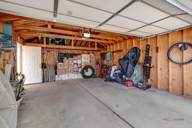 7220 W Ibsen St, Chicago, IL 60631 - garage featuring a garage door opener and wood walls