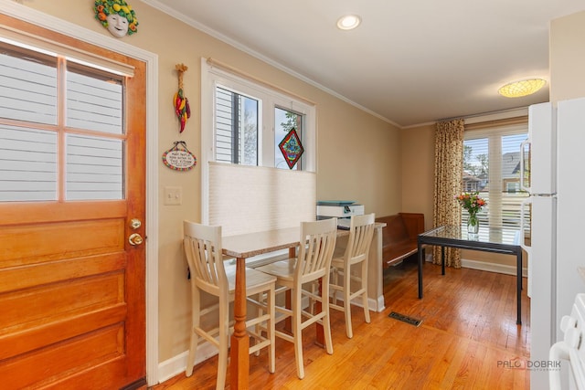 7220 W Ibsen St, Chicago, IL 60631 - dining area featuring light wood-style floors, ornamental molding, recessed lighting, and baseboards