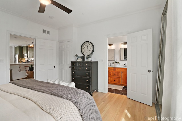 623 Broadway St, Libertyville, IL 60048 - bedroom with visible vents, freestanding refrigerator, crown molding, connected bathroom, and light wood-style flooring