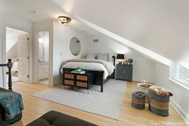 623 Broadway St, Libertyville, IL 60048 - bedroom with visible vents, wood finished floors, baseboards, a sink, and ensuite bath