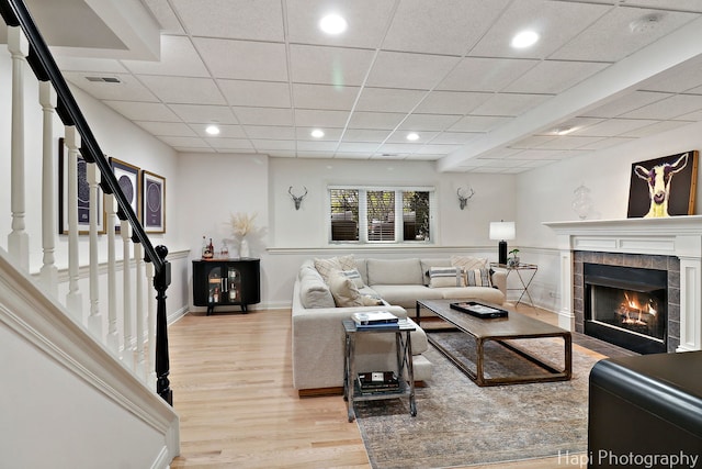 623 Broadway St, Libertyville, IL 60048 - living room with visible vents, stairs, a tile fireplace, light wood finished floors, and recessed lighting