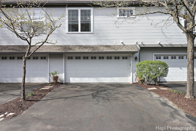 623 Broadway St, Libertyville, IL 60048 - exterior space featuring an attached garage, a shingled roof, and driveway