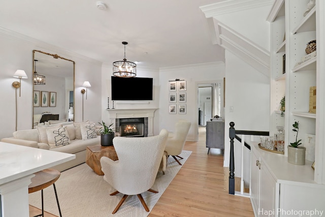 623 Broadway St, Libertyville, IL 60048 - living room with crown molding, a chandelier, a lit fireplace, and light wood finished floors