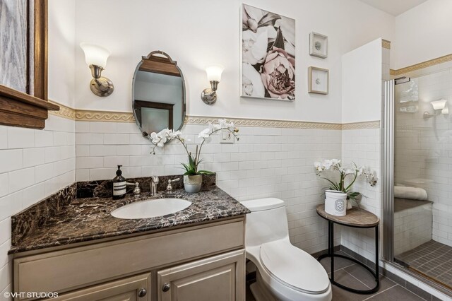2137 W Cortez St Unit 2, Chicago, IL 60622 - bathroom with a shower stall, wainscoting, toilet, vanity, and tile walls