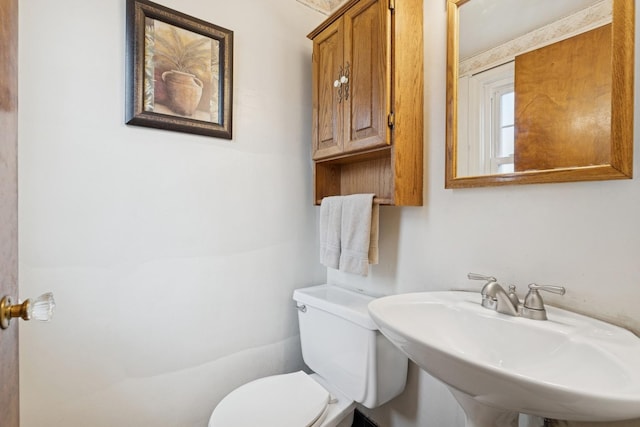 bathroom with toilet and a sink