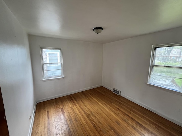 156 W 141st St, Riverdale, IL 60827 - unfurnished room featuring baseboards, visible vents, and hardwood / wood-style flooring