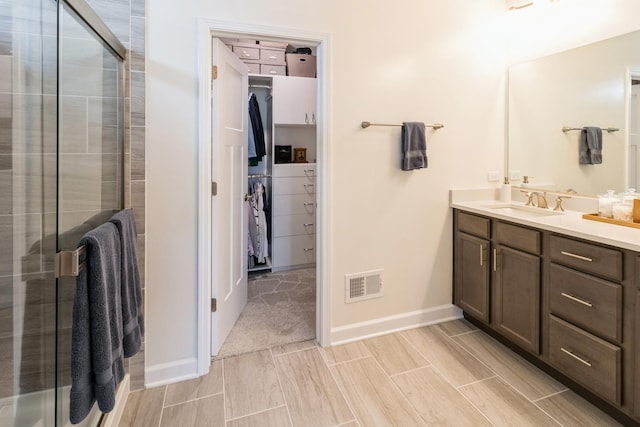 302 Links Dr, Addison, IL 60101 - bathroom featuring vanity, a walk in closet, a stall shower, and baseboards