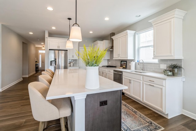 302 Links Dr, Addison, IL 60101 - kitchen with a sink, stainless steel appliances, white cabinets, a kitchen bar, and recessed lighting