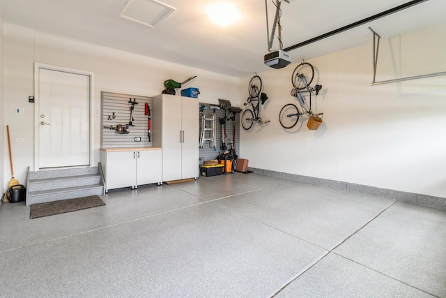 302 Links Dr, Addison, IL 60101 - garage featuring a garage door opener and baseboards