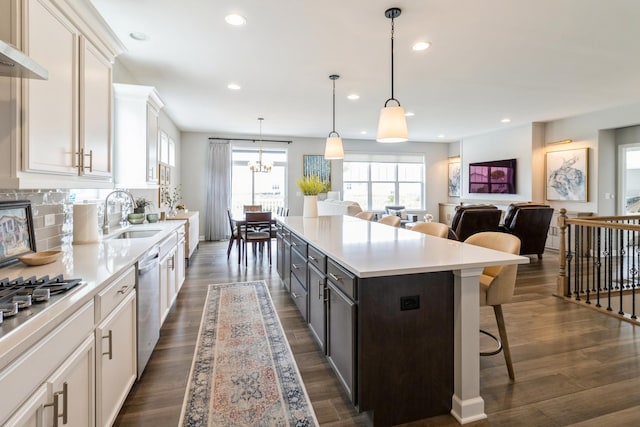 302 Links Dr, Addison, IL 60101 - kitchen with a sink, white cabinets, light countertops, recessed lighting, and a kitchen breakfast bar