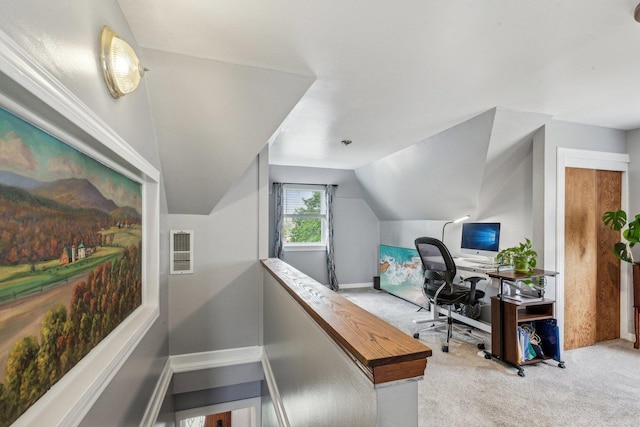 office space with light colored carpet, visible vents, baseboards, and lofted ceiling