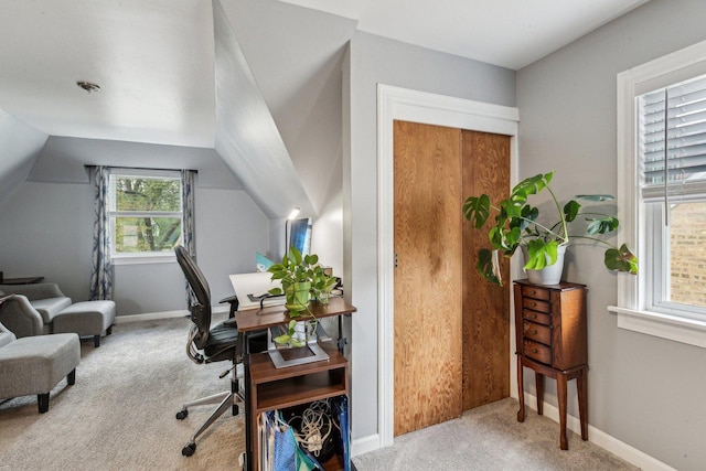 office featuring lofted ceiling, a wealth of natural light, carpet floors, and baseboards