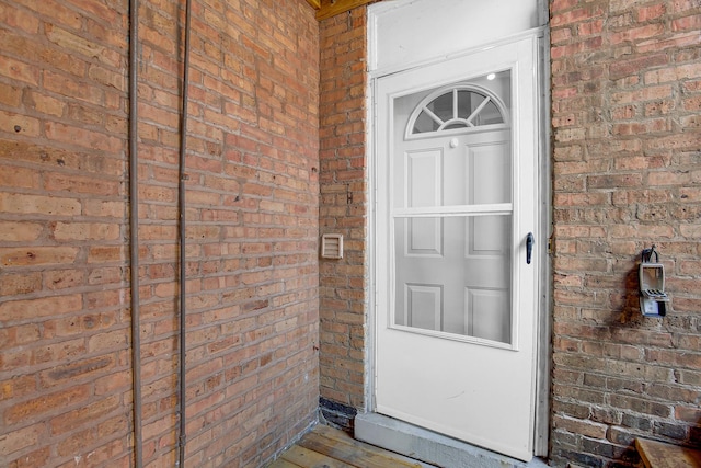 property entrance featuring brick siding