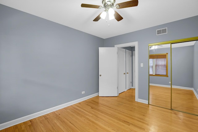 unfurnished bedroom featuring baseboards, light wood-type flooring, a closet, and ceiling fan