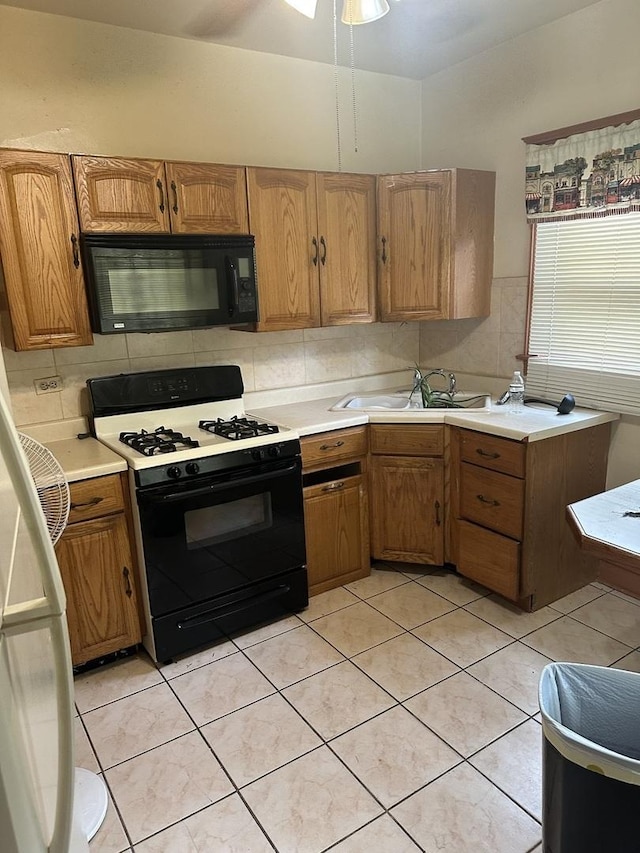 8042 S Bennett Ave, Chicago, IL 60617 - kitchen featuring black appliances, light countertops, light tile patterned floors, and decorative backsplash