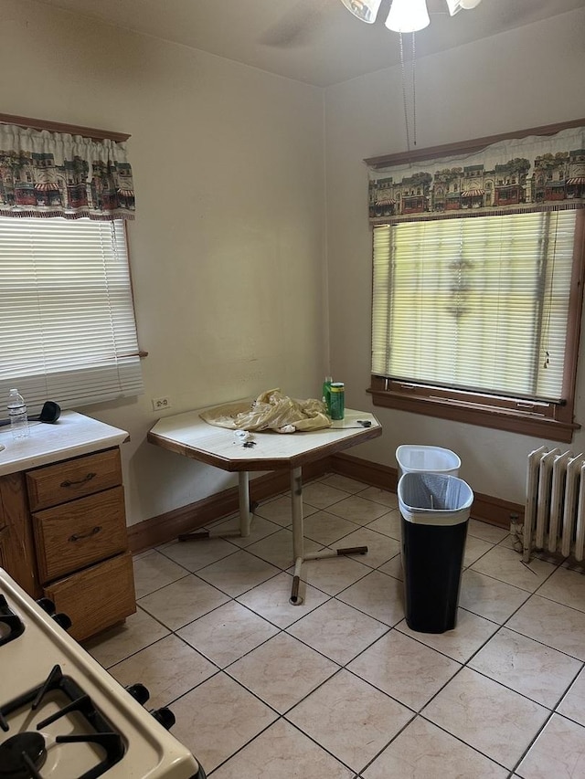 8042 S Bennett Ave, Chicago, IL 60617 - dining space with radiator heating unit, light tile patterned flooring, and a ceiling fan