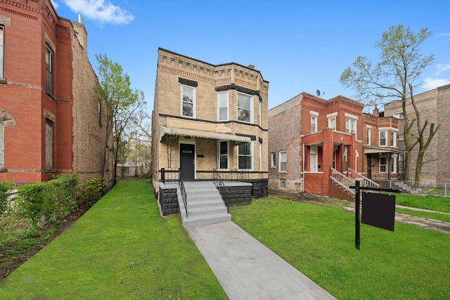 view of front of home with brick siding and a front lawn