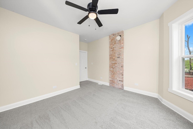 carpeted empty room with baseboards and ceiling fan