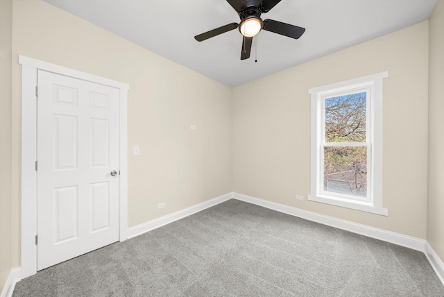 empty room featuring baseboards, ceiling fan, and carpet flooring
