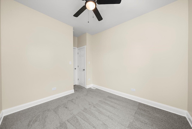 spare room with carpet flooring, baseboards, and ceiling fan