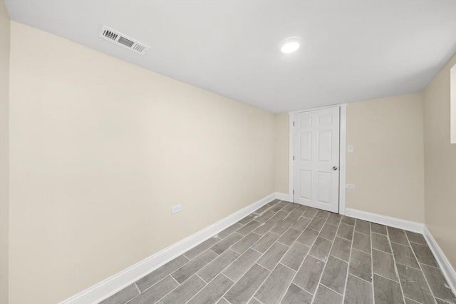 empty room featuring recessed lighting, baseboards, visible vents, and wood finished floors