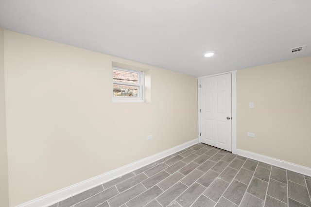 basement featuring recessed lighting, baseboards, and visible vents