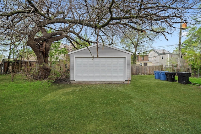 detached garage featuring fence