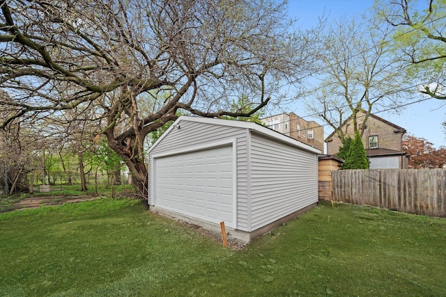 detached garage featuring fence