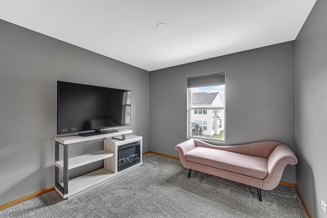 living area with a fireplace, carpet flooring, and baseboards