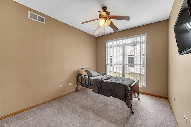 carpeted bedroom featuring baseboards, multiple windows, and visible vents