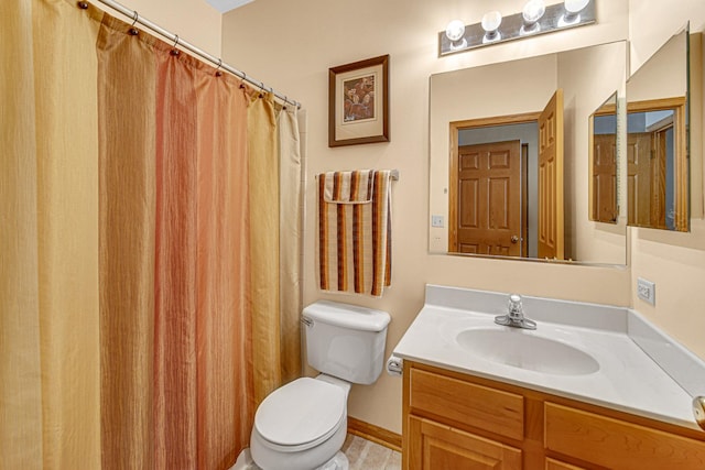 bathroom featuring toilet and vanity