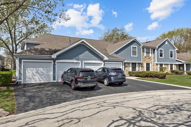 314 Wildberry Ct Unit A1, Schaumburg, IL 60193 - view of front of house featuring asphalt driveway, a garage, stone siding, and a shingled roof
