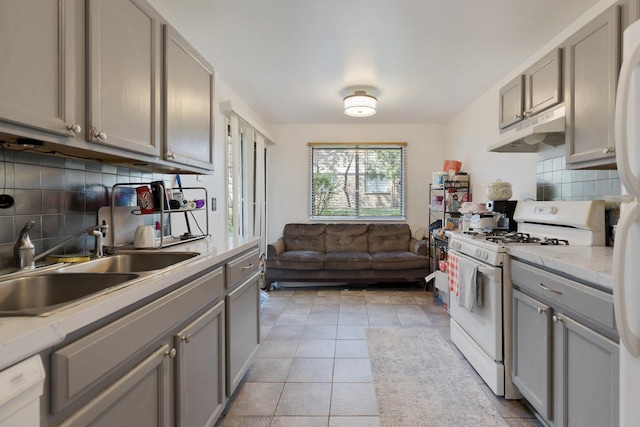 314 Wildberry Ct Unit A1, Schaumburg, IL 60193 - kitchen with white appliances, under cabinet range hood, gray cabinetry, tasteful backsplash, and a sink