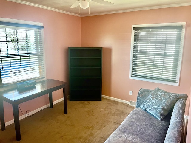 sitting room featuring carpet flooring, baseboards, crown molding, and ceiling fan