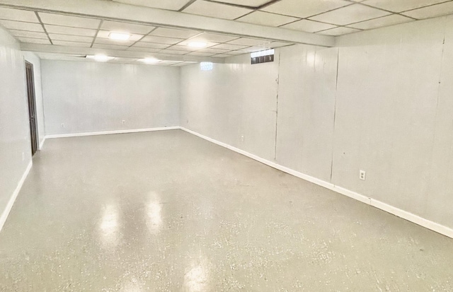 finished below grade area with a drop ceiling and baseboards