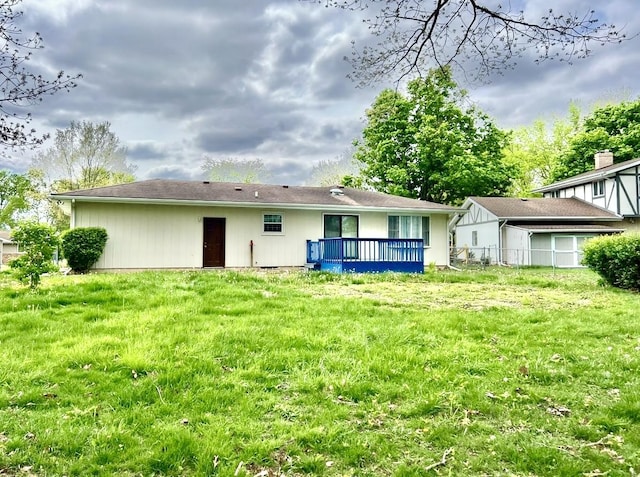 rear view of property featuring a wooden deck