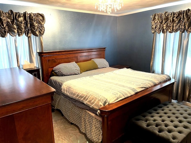 bedroom featuring ornamental molding and a chandelier