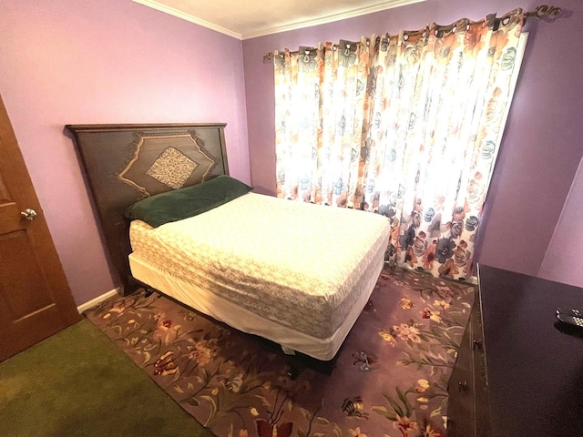 carpeted bedroom featuring crown molding