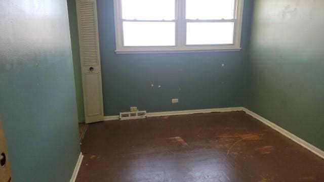 spare room with baseboards and visible vents