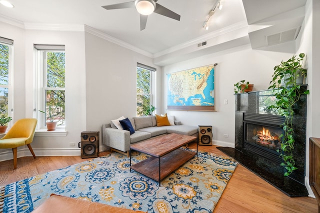 1610 N Whipple St Unit 2, Chicago, IL 60647 - living room with wood finished floors, healthy amount of natural light, a tile fireplace, ornamental molding, and baseboards