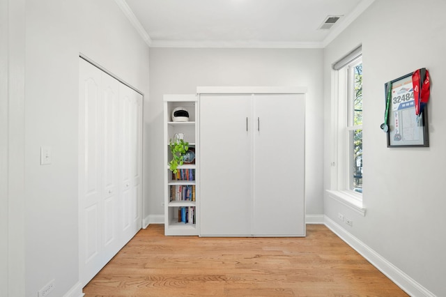 1610 N Whipple St Unit 2, Chicago, IL 60647 - unfurnished bedroom featuring multiple closets, wood finished floors, ornamental molding, and baseboards